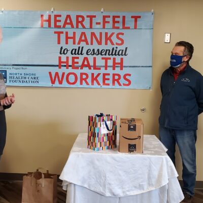 Health Care Foundation President Jerry Lilja presents the gifts to Sawtooth Mountain Clinic CEO Kate Surbaugh. Photo R. Silence