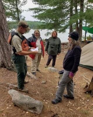 Wilderness rangers meet with BWCA paddlers during 2021 evacuation. Photo courtesy of USDA Forest Service