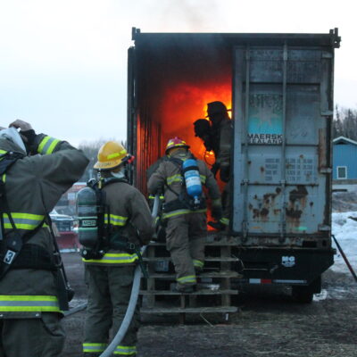 Firefighters enter the live burn trailer.