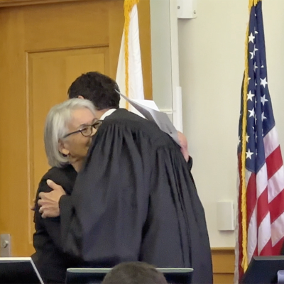 Vice-Chair Armstrong and Judge Hanke hug