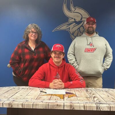 Hunter Rex signing letter of intent with parents | Photo by Michael McHugh