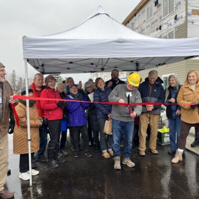 Gary Latz cuts the ribbon outside the Heights