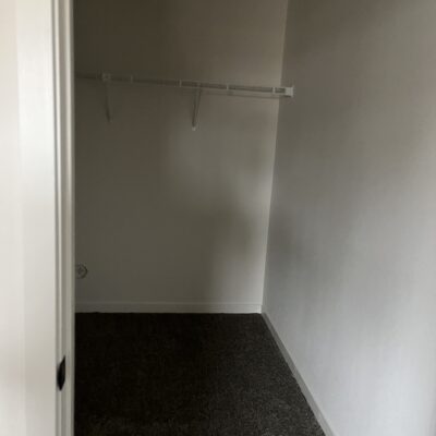 a large closet in a one bedroom apartment