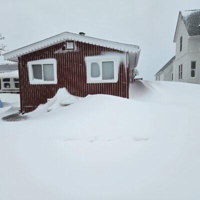 Snow drift nears roof at World's Best Donuts