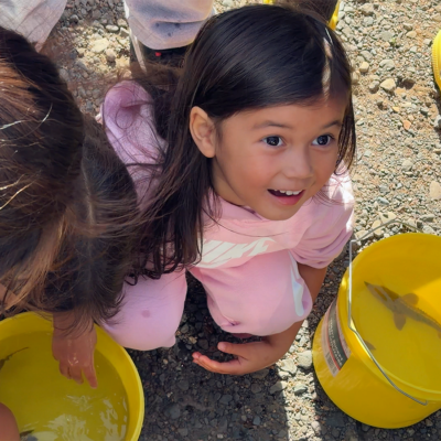 Student smiling with sturgeon bucket